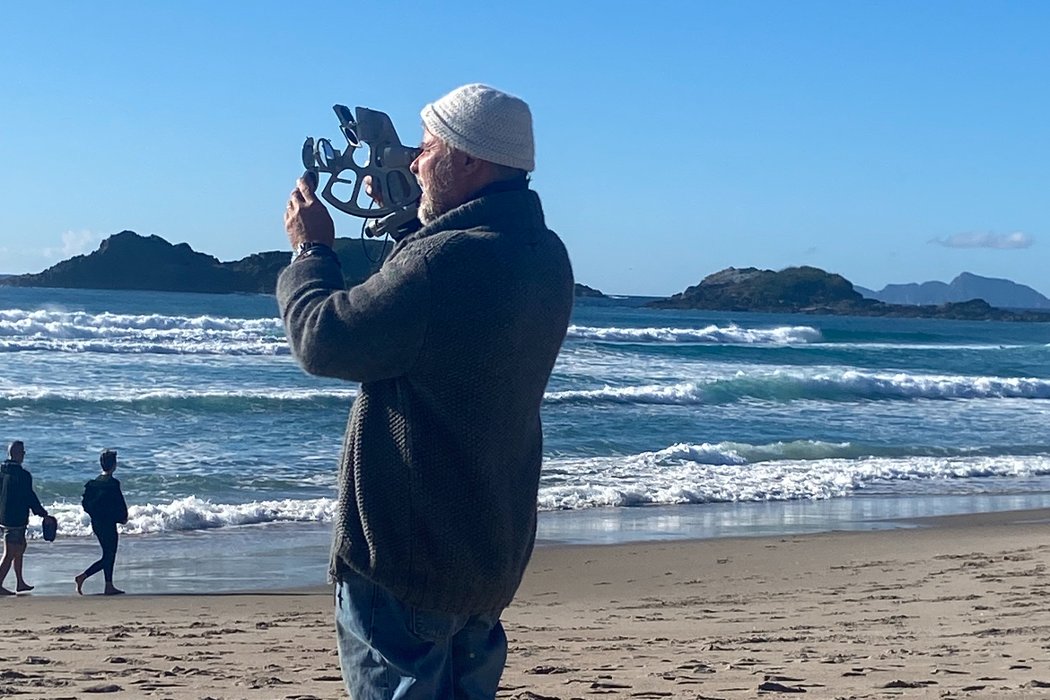 Dave Lewis, founder and instructor, taking a sextant sight on the beach