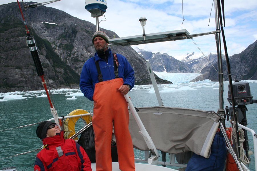 Alvah and Diana Simon aboard their yacht in Alaska, with a glacier and ice in the background