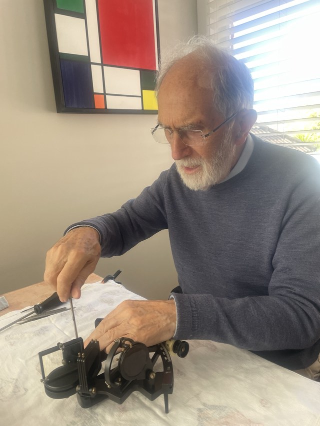 Bill Morris repairing a marine sextant at his desk