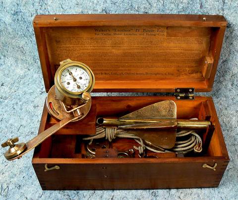 The Walker Excelsior IV open, showing the mile-register dial, the rotator, and the coiled tow line